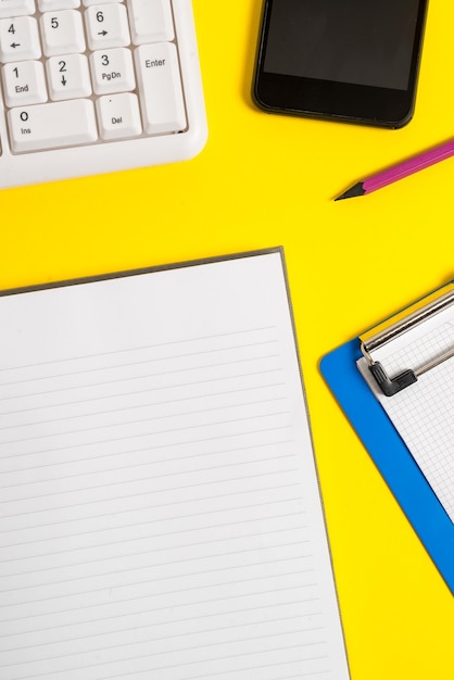 A close-up of a financial aid award letter with key figures highlighted in yellow. A calculator and pen are placed beside the letter, suggesting careful review and calculation.