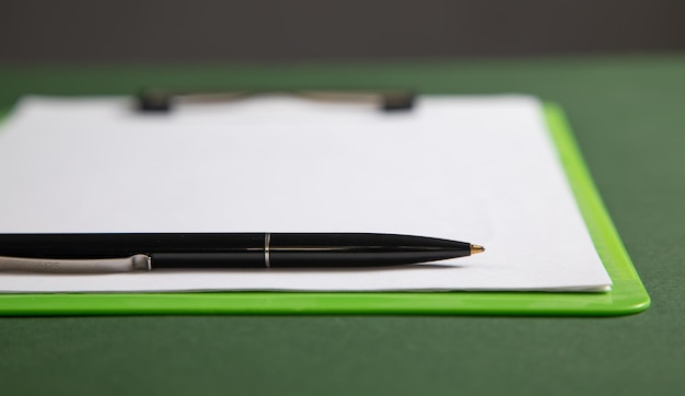 A close-up of a FAFSA form with a pen hovering over a specific section, highlighting the importance of accuracy.