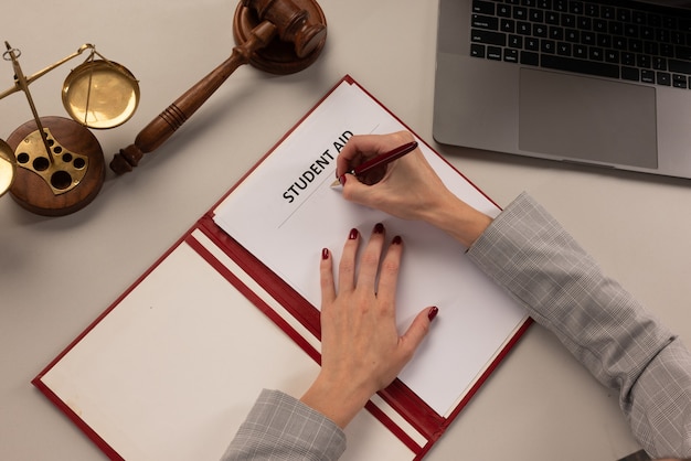 A close-up shot of a FAFSA application form being filled out with a pen, with the words 