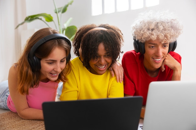 A diverse group of students studying together online using laptops and tablets, symbolizing the accessibility and collaboration in online education.