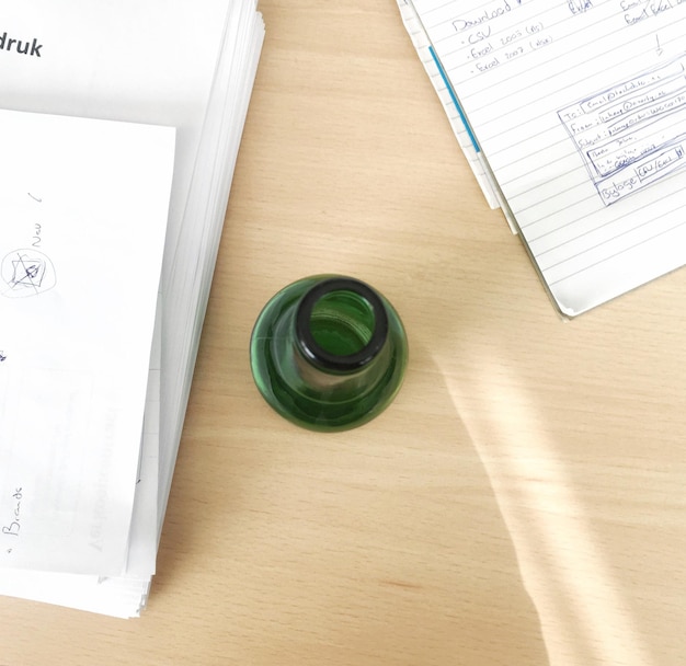 A close-up shot of the FAFSA application form, partially filled out, with a pen resting on top. The form is lying on a desk with a calculator and a notebook in the background.