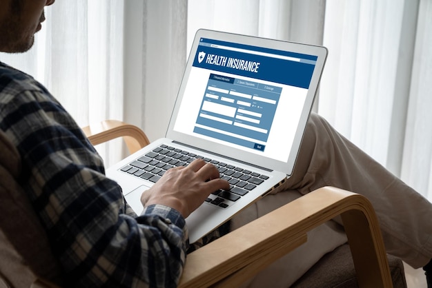 A person typing on a computer with a screen displaying a state government website for unclaimed property. The focus is on the hands typing and the website interface.