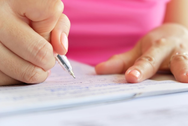 A close-up shot of an application form for childcare assistance, with a pen hovering over the signature line. Focus on the paperwork and process involved.