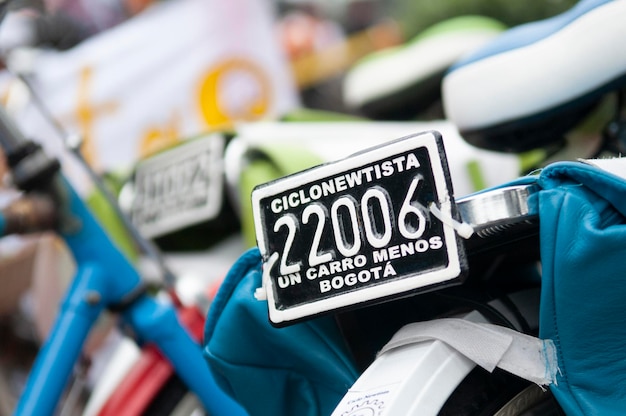 A close-up of a vehicle identification number (VIN) plate on an electric vehicle, with a magnifying glass hovering over it, symbolizing the act of verifying the vehicle's eligibility for the tax credit.