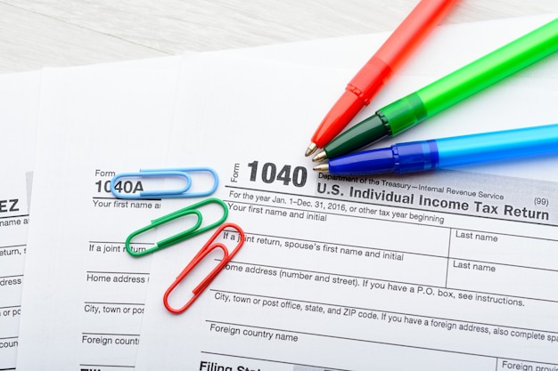 A close-up shot of a tax form (Form 1040) with the section for claiming the Child Tax Credit highlighted. A pen rests on the form, symbolizing the process of tax preparation.