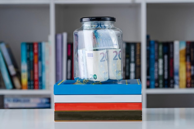 A stack of textbooks and a student ID card on a desk, symbolizing qualified education expenses for the American Opportunity Tax Credit.