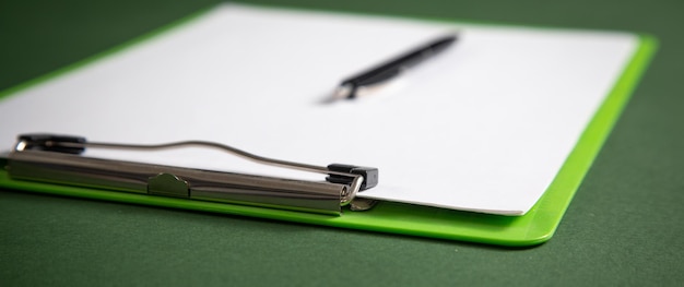 A close-up of a FAFSA application form with a pen hovering over the asset section.
