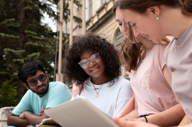 A diverse group of students studying together in a brightly lit and modern student union, showcasing inclusivity in higher education.