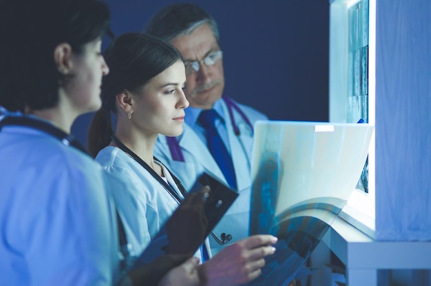 A modern healthcare facility with advanced medical technology and staff collaborating, illustrating the impact of technology on healthcare and the potential for growth stocks in this sector.