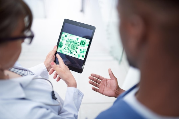 A doctor using a tablet to consult with a patient remotely via telemedicine, illustrating the growing trend of digital healthcare and its accessibility.