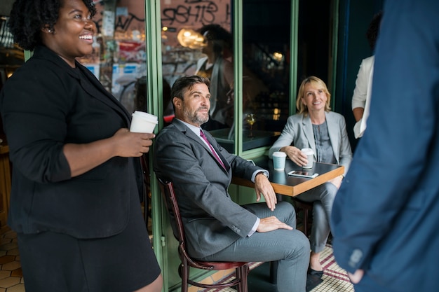 A diverse group of business owners at a networking event, with a backdrop of a state capitol building, symbolizing the importance of local connections and state resources for small businesses.
