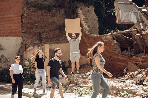 Image of people in a community working together to clear debris and rebuild after a disaster, symbolizing community resilience and mutual support.