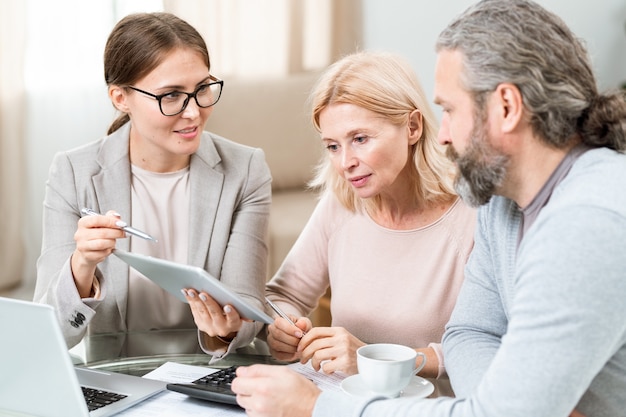 An image of a family discussing healthcare options with a financial advisor, illustrating the importance of understanding available financial assistance programs. The setting is a warm and inviting office.