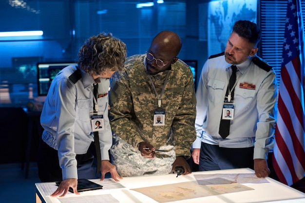 A US veteran in a professional setting, confidently presenting a project to colleagues. The scene takes place in a modern office, highlighting the veteran's integration into the civilian workforce.