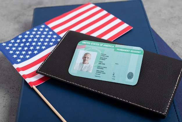 A close-up of a US Social Security card, highlighting the cardholder's name and social security number, with a blurred background of tax forms.