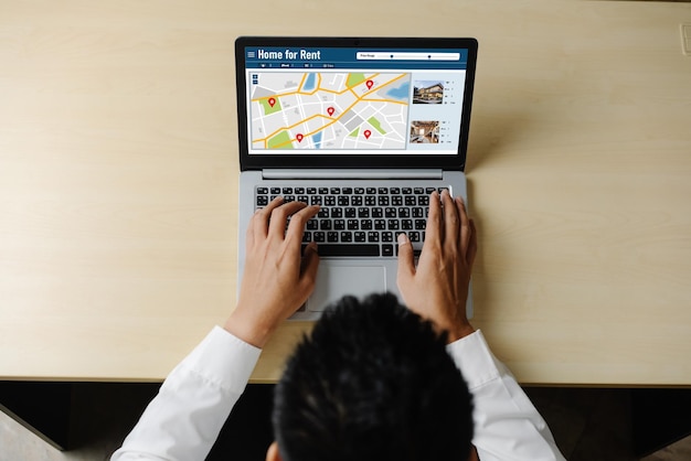 A person using a laptop to search for VITA and TCE sites using the IRS's online locator tool. The screen displays a map with highlighted locations, indicating nearby free tax preparation services.