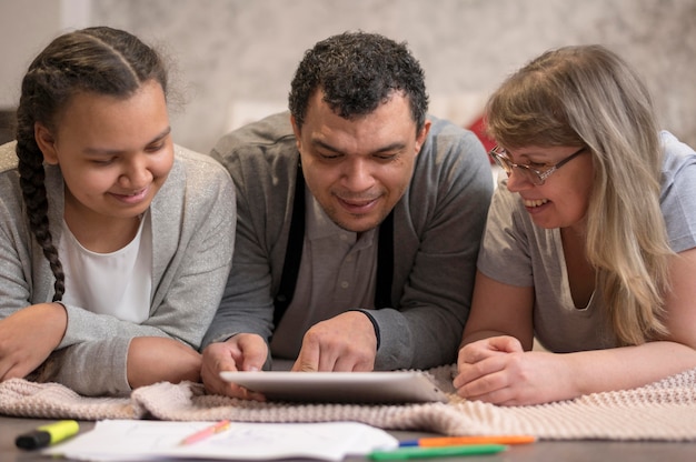 A group of students in a classroom, with one student filling out the FAFSA form on a tablet, emphasizing the importance of meeting deadlines.