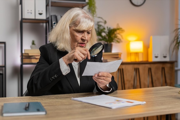 An image of a person reviewing tax documents with a magnifying glass, emphasizing the importance of accuracy and detail. The lighting should be warm and inviting.