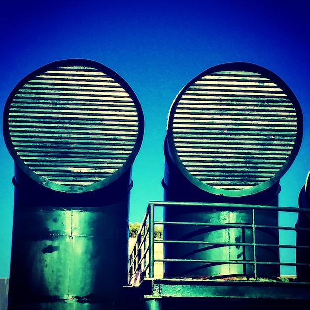 A split-screen image showing a traditional gas furnace on one side and a modern geothermal heat pump on the other. The image contrasts old and new energy technologies.
