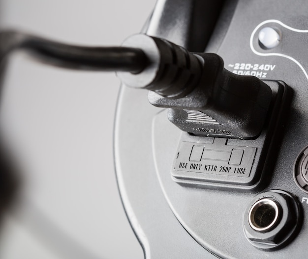 A close-up image of a car's charging port with a visible electric cable plugged in, symbolizing the charging process of an EV.