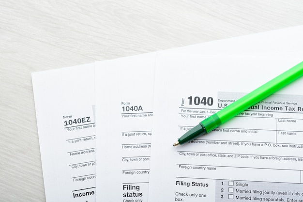 A close-up of a 1040 tax form highlighting the section for education credits, with a pen resting beside it.