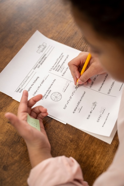 A close-up shot of a Form 2441, with a pen pointing to the section about qualifying persons for the Child and Dependent Care Tax Credit. The background is blurred, focusing attention on the form.