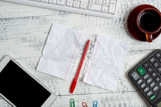 A close-up shot of receipts and tax forms organized on a desk. A pen is resting on top of one of the forms, ready to be filled out.