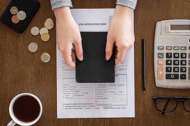 A close-up of hands filling out a tax form related to individual tax credits, emphasizing accuracy and attention to detail.