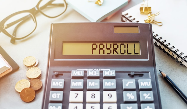 A close-up shot of a calculator displaying a calculation of tax credits. The background is blurred, featuring U.S. currency and tax forms, symbolizing the financial aspects of the Child Tax Credit.