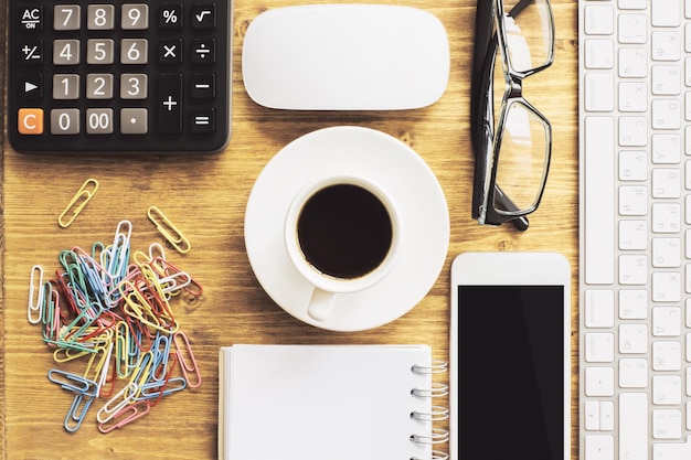 An organized desk with tax documents neatly arranged, a calculator, and a cup of coffee. The scene suggests careful and methodical tax preparation. The lighting is warm and inviting, highlighting the comfort of handling finances in a structured environment.