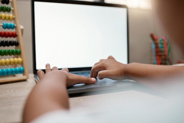 A close-up of a computer screen displaying a coding tutorial, with hands typing on a keyboard. The background shows a supportive classroom environment with diverse students learning together. This image highlights the IT training aspect of state-funded programs.